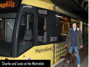 A photo of Charlie Allen with her dog Lexie beside a Bury tram